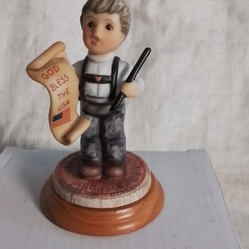 Berta Hummel's '"God Bless The U.S.A."  little boy Figurine holding a sign.